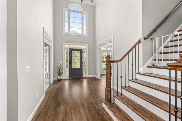 a view of an entryway with wooden floor and stairs