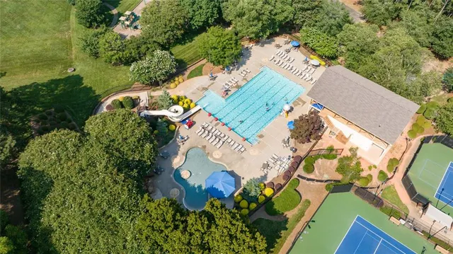 an aerial view of a house with a yard and outdoor seating