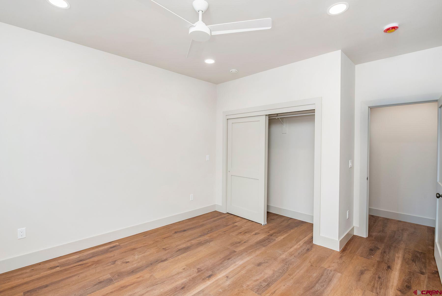 180 Elk Valley Road, Unit 104 Crested Butte, CO 81224 - Photo 18 of 27 an empty room with wooden floor and closet