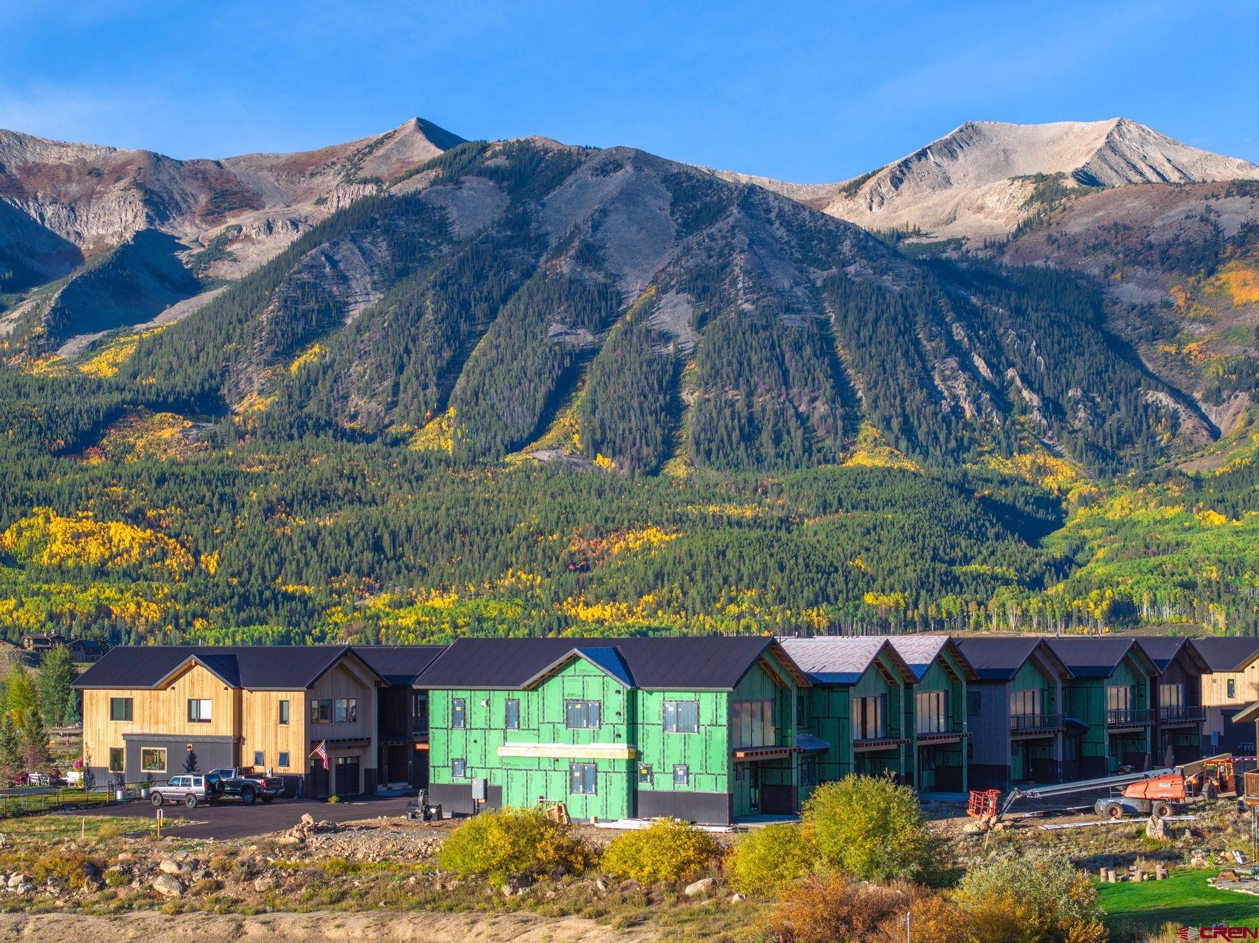 180 Elk Valley Road, Unit 104 Crested Butte, CO 81224 - Photo 24 of 27 a view of a cafe with a table and chairs under an umbrella
