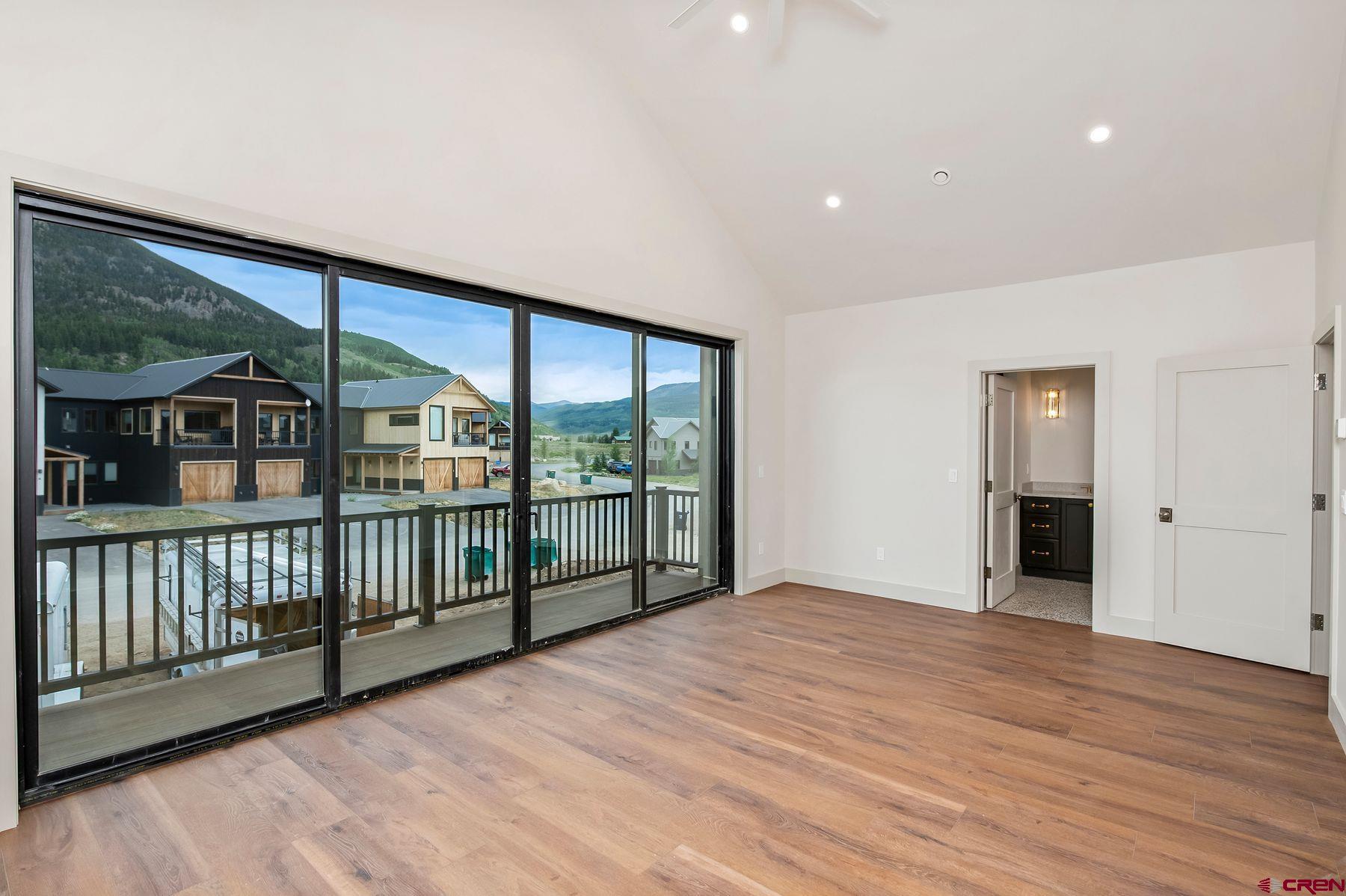 180 Elk Valley Road, Unit 104 Crested Butte, CO 81224 - Photo 7 of 27 a view of an empty room with wooden floor and a window