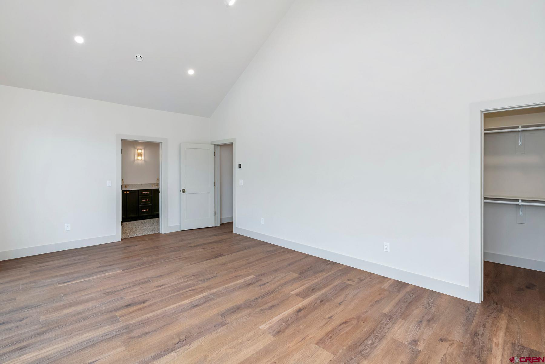 180 Elk Valley Road, Unit 104 Crested Butte, CO 81224 - Photo 9 of 27 a view of an empty room with wooden floor and closet