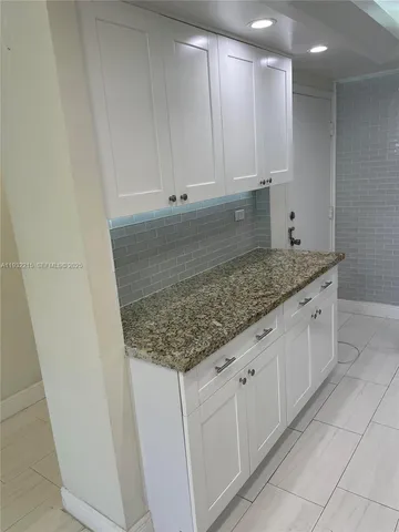 a kitchen with white cabinets