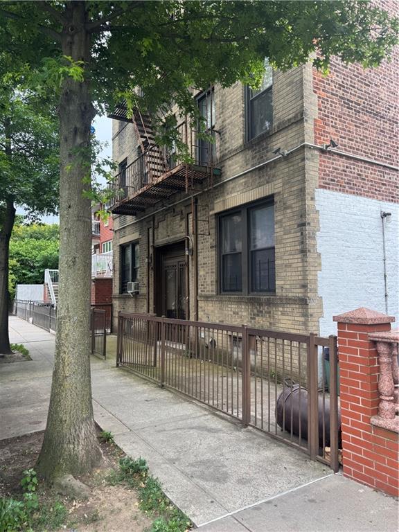 1926 83rd Street Brooklyn, NY 11214 - Photo 3 of 13 a view of a house with a balcony and wooden fence
