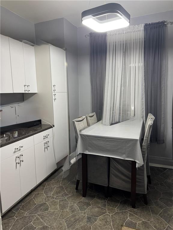 1926 83rd Street Brooklyn, NY 11214 - Photo 5 of 13 a room with a table chairs and wooden floor