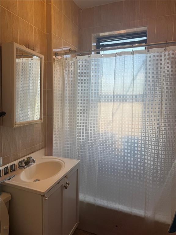 1926 83rd Street Brooklyn, NY 11214 - Photo 8 of 13 a bathroom with a sink and shower