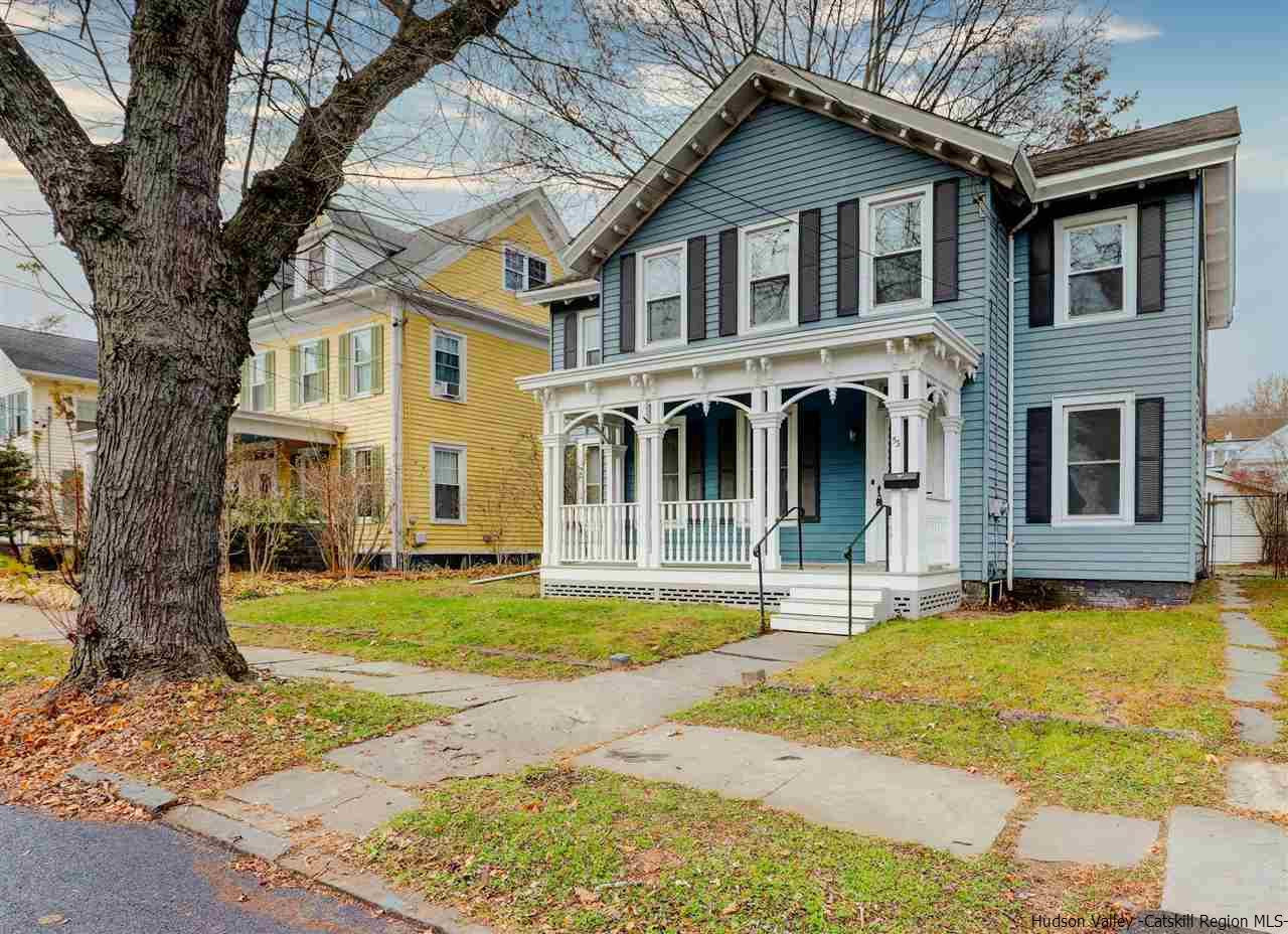 a front view of a house with a yard table and chairs