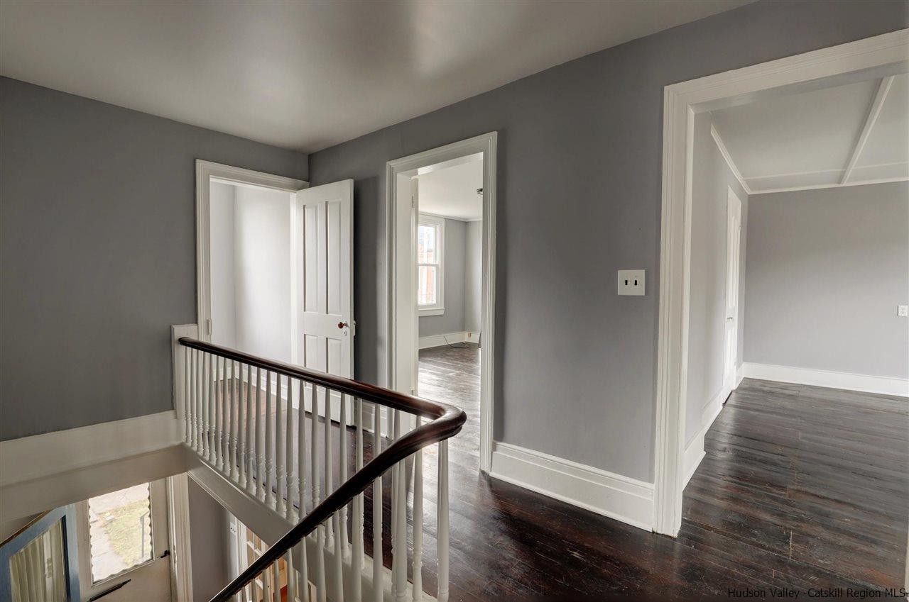 53 Spring Street Kingston, NY 12401 - Photo 15 of 26 a view of a hallway with wooden floor and stairs