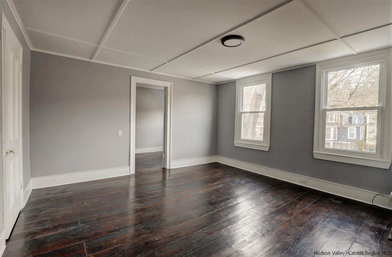 53 Spring Street Kingston, NY 12401 - Photo 20 of 26 a view of an empty room with wooden floor and a window