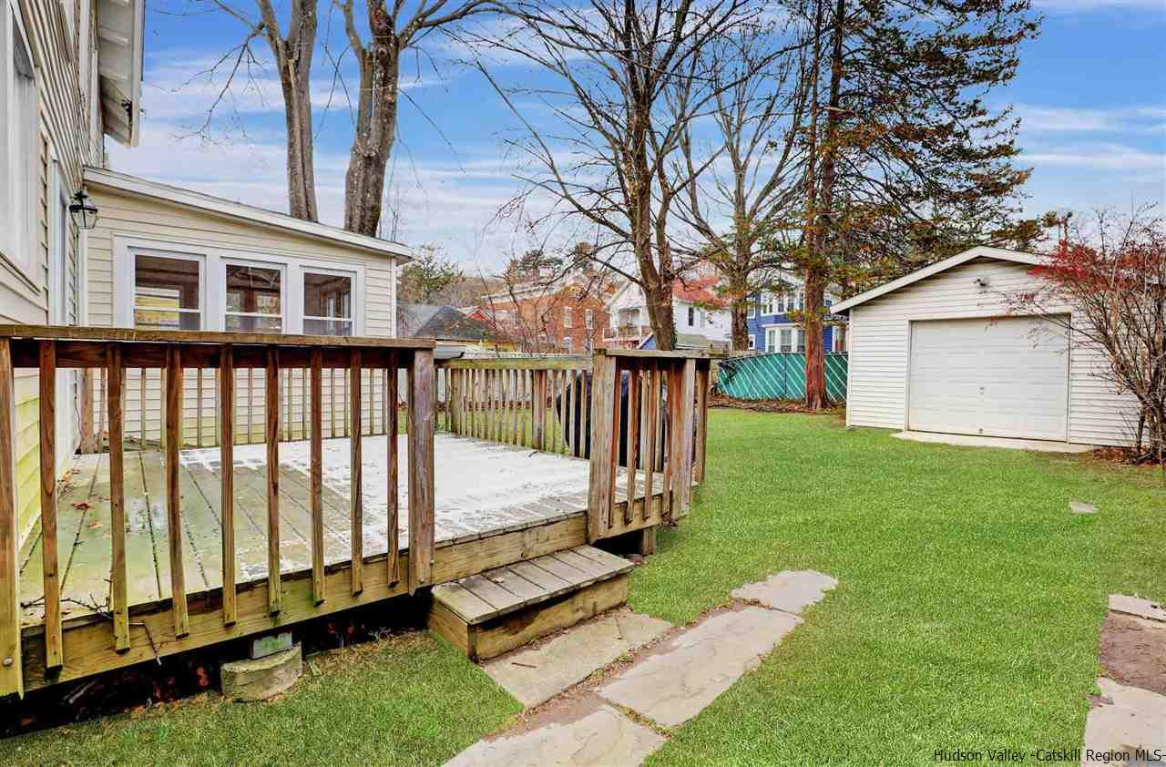 53 Spring Street Kingston, NY 12401 - Photo 24 of 26 a view of a white house with a big yard and large trees