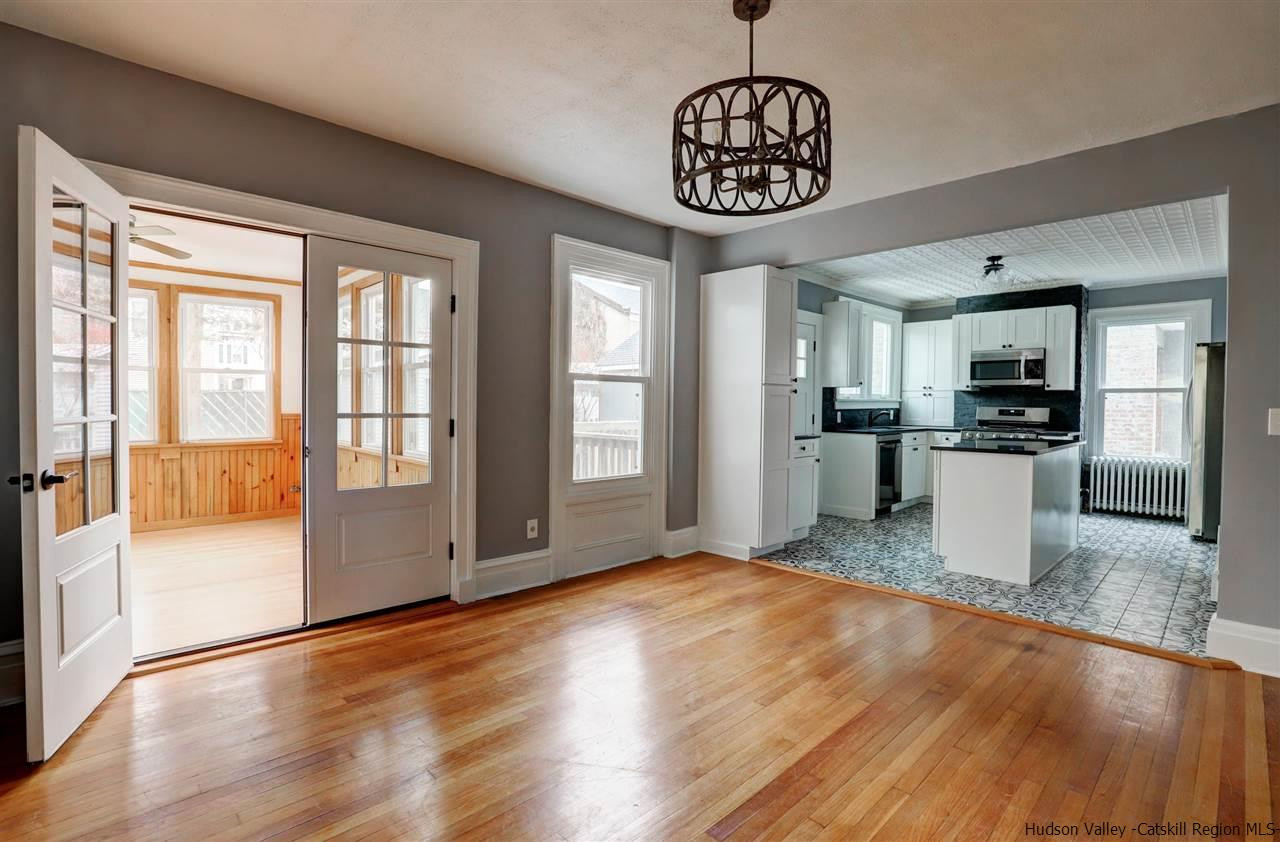 53 Spring Street Kingston, NY 12401 - Photo 8 of 26 a view of a kitchen with stainless steel appliances granite countertop a refrigerator a stove top oven a sink with wooden floor and cabinets