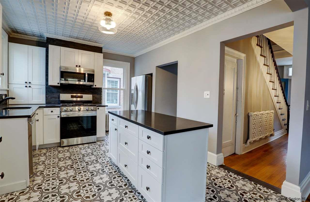 53 Spring Street Kingston, NY 12401 - Photo 10 of 26 a kitchen with granite countertop a refrigerator and a stove