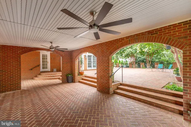 a large kitchen with kitchen island granite countertop a stove a refrigerator a sink a dining table and chairs with wooden floor