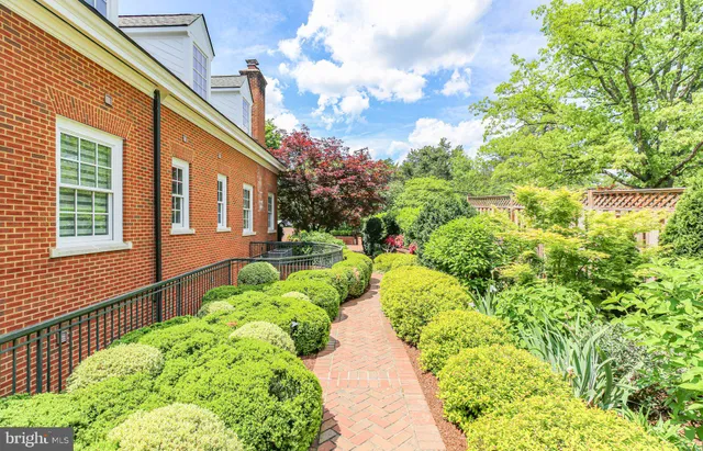 a kitchen with stainless steel appliances granite countertop a sink a counter space and a window