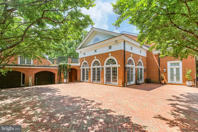 a spacious bathroom with a double vanity sink mirror and bathtub