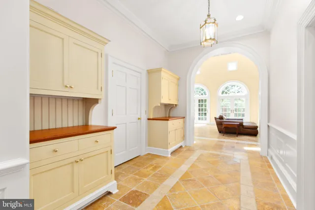 a balcony with flower plants and wooden fence