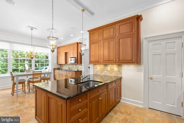an aerial view of residential house with outdoor space and trees all around