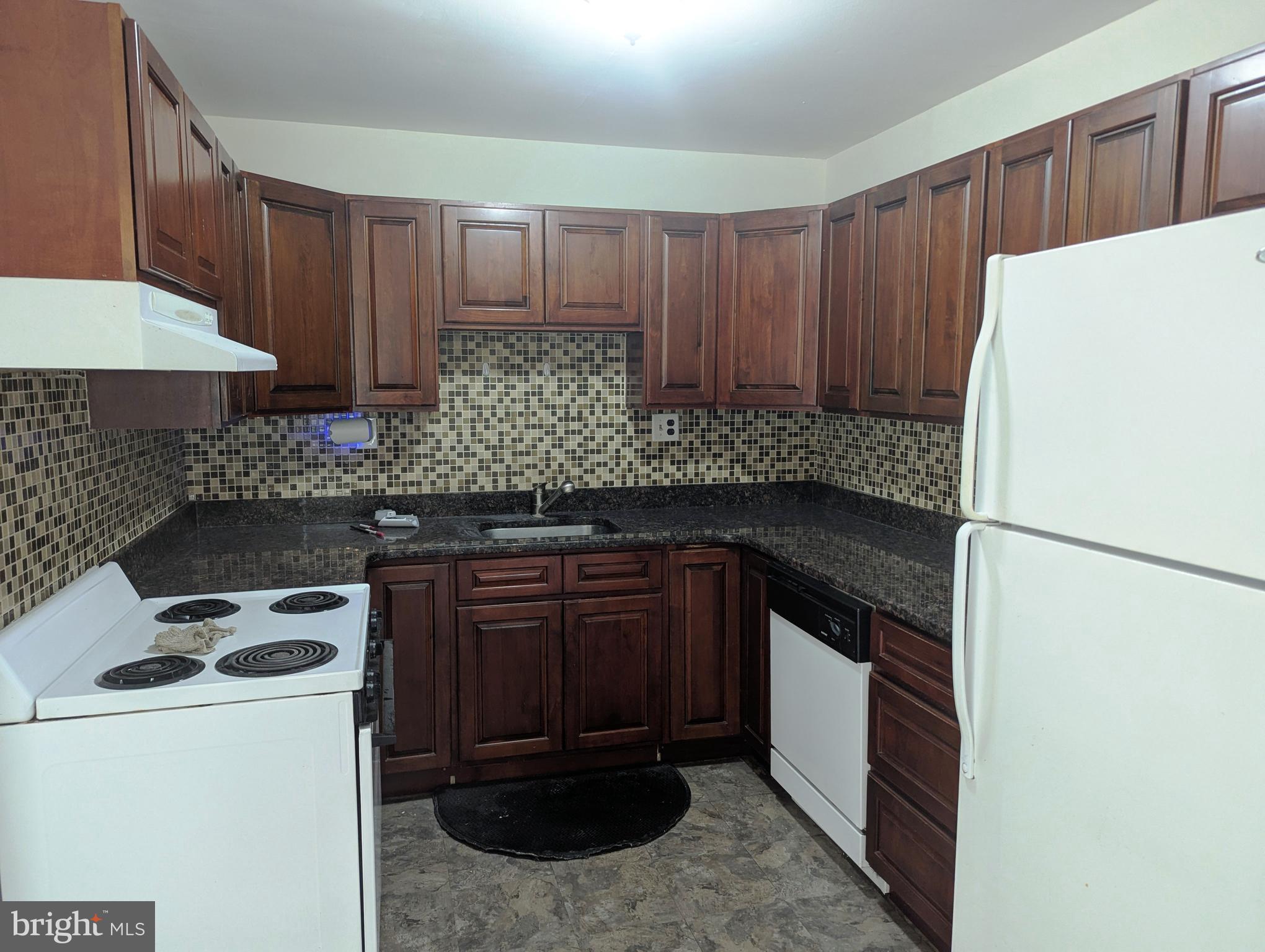 2886 Limekiln Pike, Unit C Glenside, PA 19038 - Photo 5 of 10 a kitchen with a refrigerator and a stove