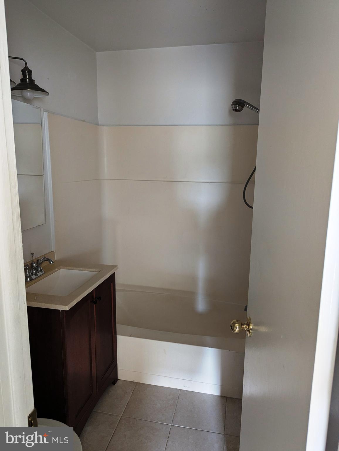 2886 Limekiln Pike, Unit C Glenside, PA 19038 - Photo 8 of 10 a bathroom with a sink and shower