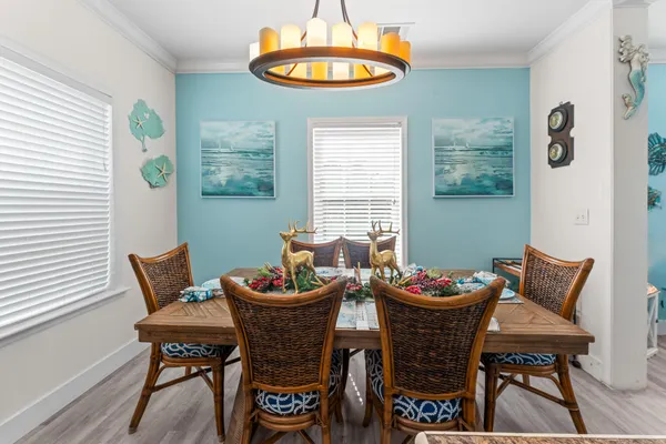 a living room with furniture chess table and a chandelier