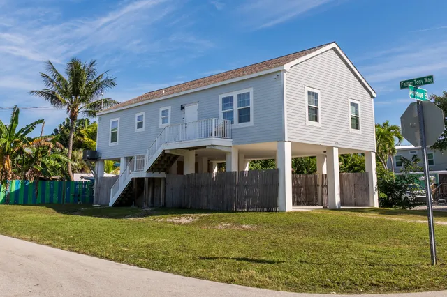 a front view of house with yard and outdoor seating