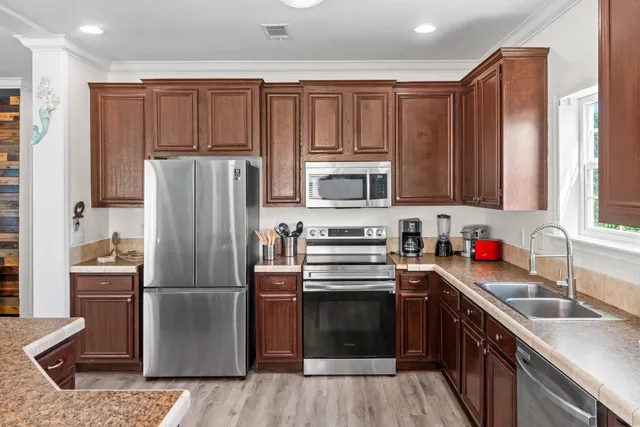 a kitchen with a refrigerator sink and microwave