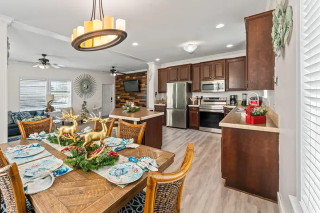 a living room with stainless steel appliances kitchen island granite countertop furniture and a kitchen view