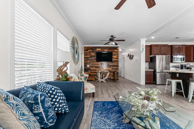 a living room with furniture flowerpot and wooden floor