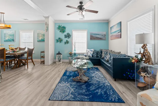 a living room with furniture chess table and a chandelier