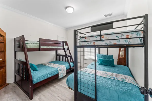 a bedroom with bed and a chandelier