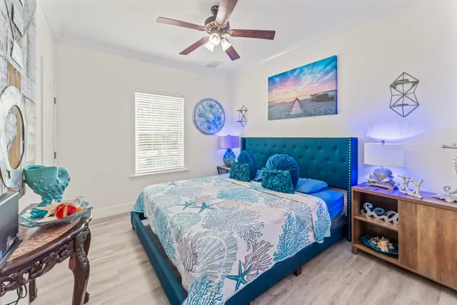 a bedroom with bed and a chandelier