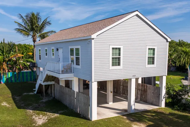 a front view of house with yard and outdoor seating