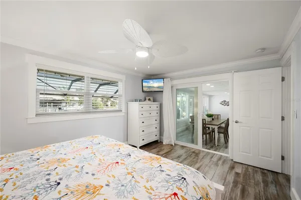 a bedroom with a bed and painting on the wall