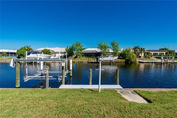 an aerial view of a house with a swimming pool outdoor seating and yard view