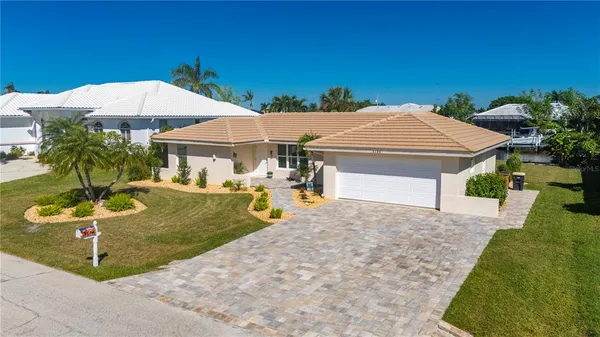 an aerial view of residential houses with outdoor space and swimming pool
