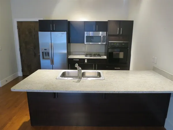 a kitchen with a sink a refrigerator and washer