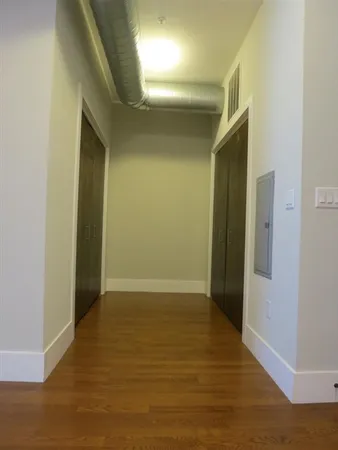 a view of hallway with hardwood floor