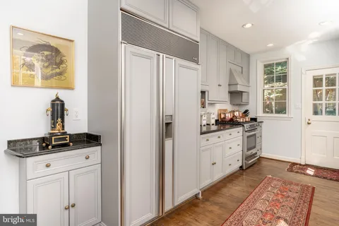 a bathroom with a sink mirror and shower