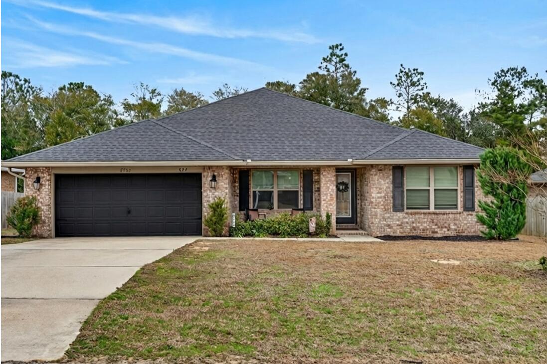 5733 Marigold Loop Crestview, FL 32539 - Photo 1 of 45 a front view of a house with a garden