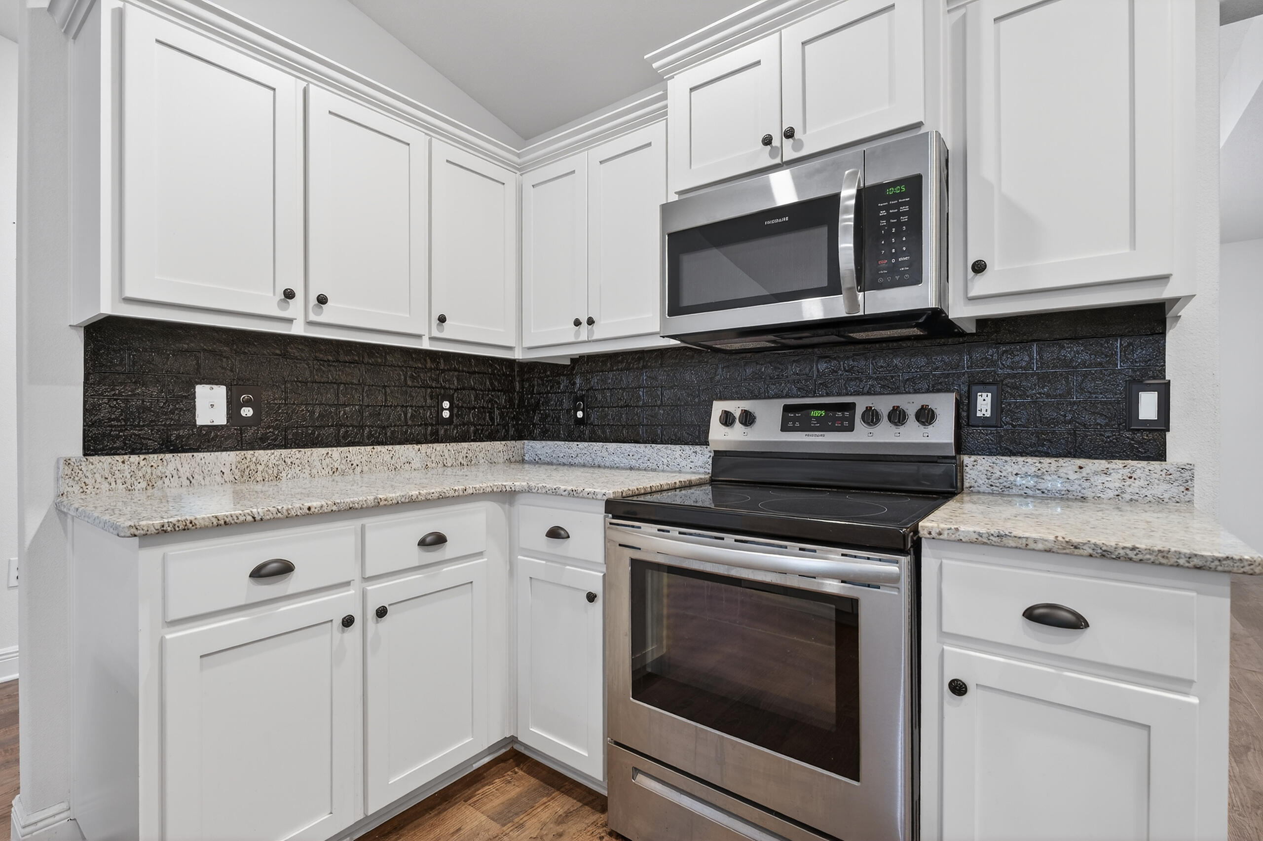 5733 Marigold Loop Crestview, FL 32539 - Photo 19 of 45 a kitchen with granite countertop white cabinets and stainless steel appliances