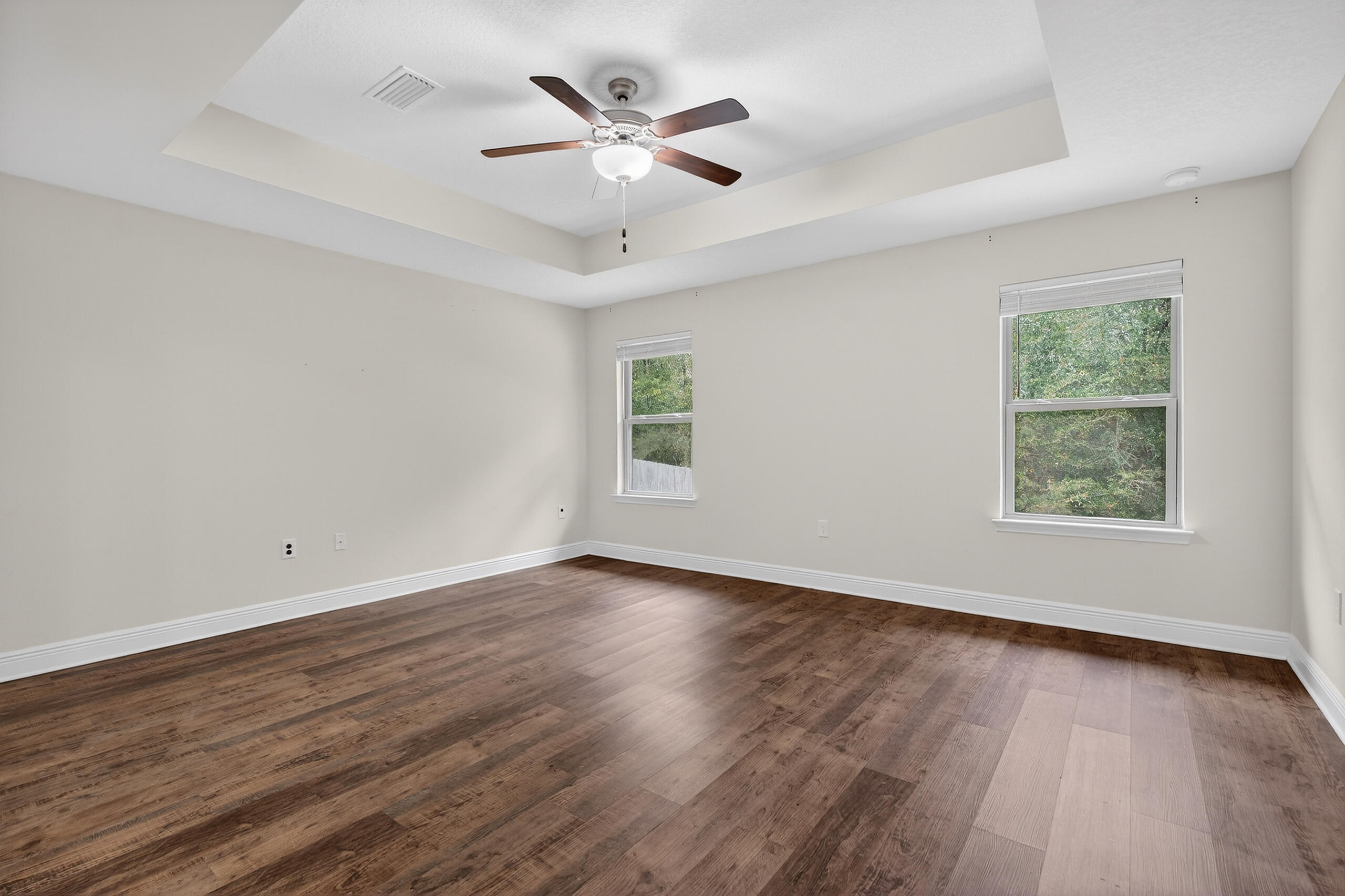 5733 Marigold Loop Crestview, FL 32539 - Photo 28 of 45 an empty room with wooden floor and windows