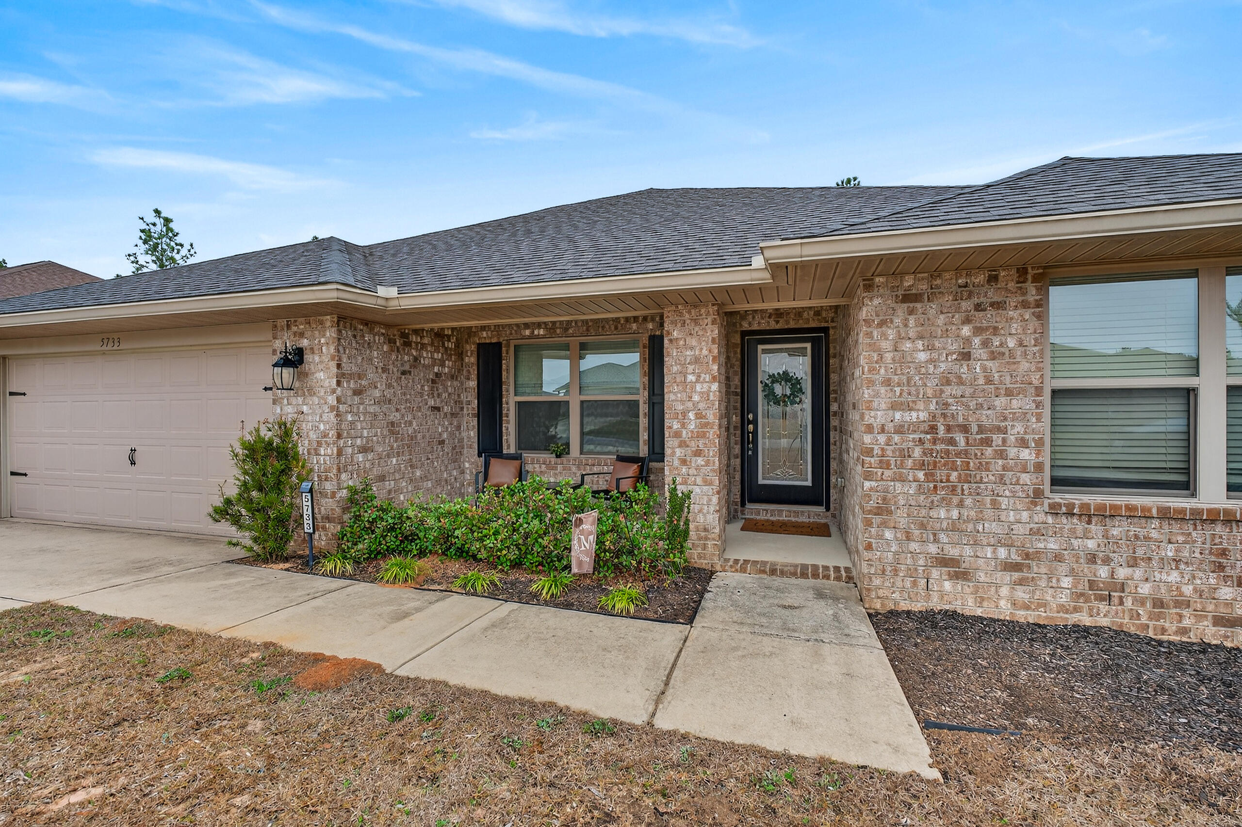 5733 Marigold Loop Crestview, FL 32539 - Photo 6 of 45 front view of a brick house with a yard