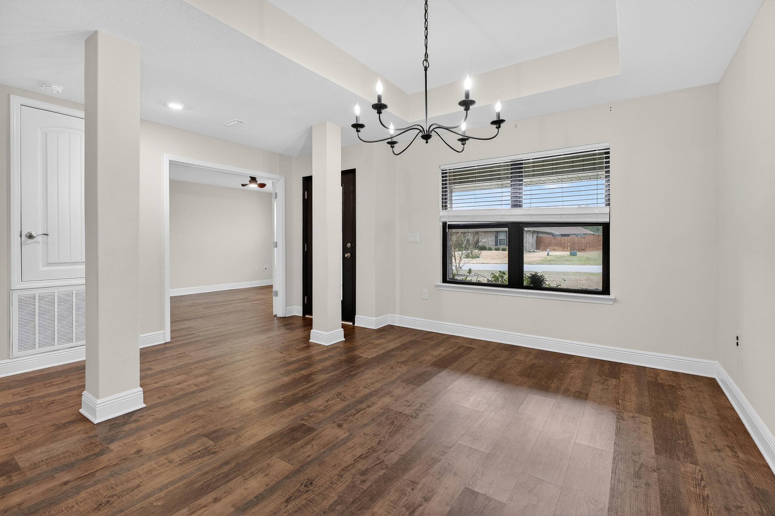 5733 Marigold Loop Crestview, FL 32539 - Photo 10 of 45 a view of an empty room with wooden floor and a window