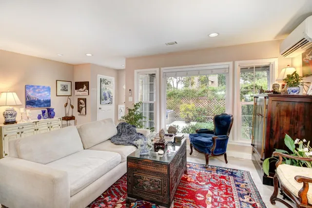 a living room with furniture and a floor to ceiling window