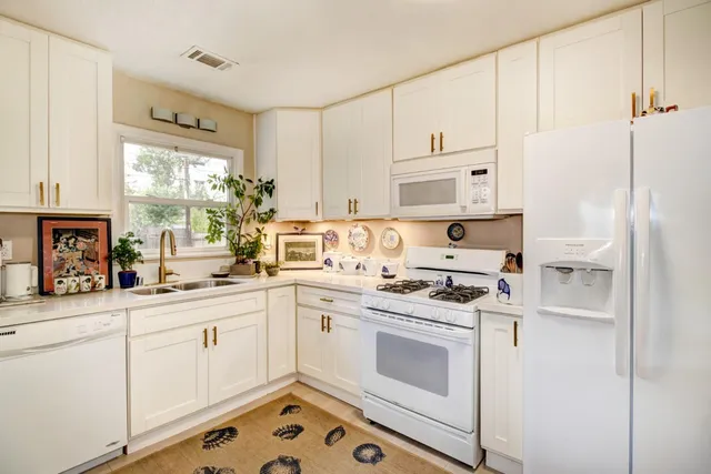 a kitchen with a stove a sink and a refrigerator