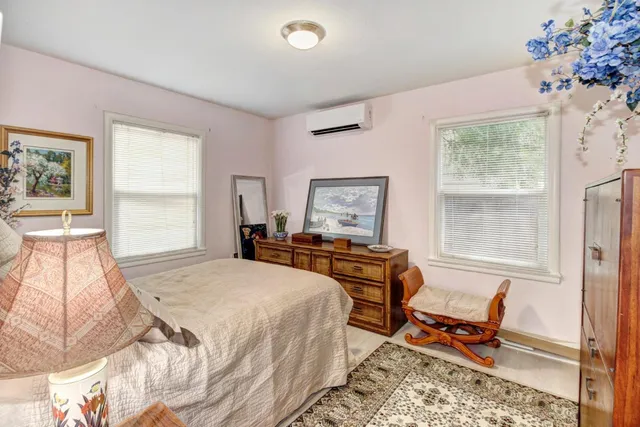 a bedroom with furniture and a window