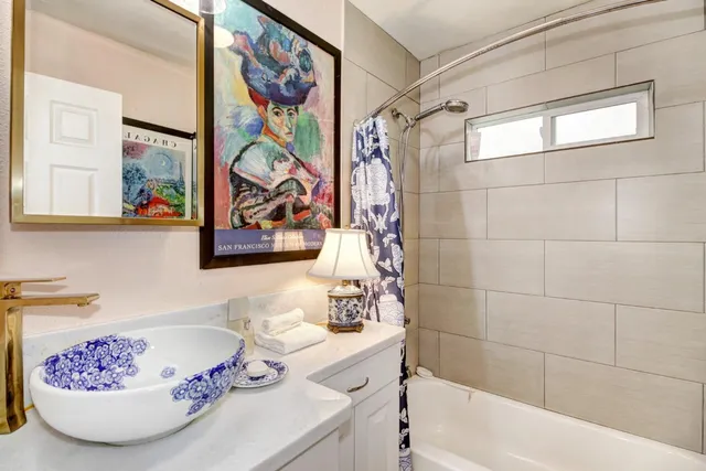 a bathroom with a bathtub and a shower