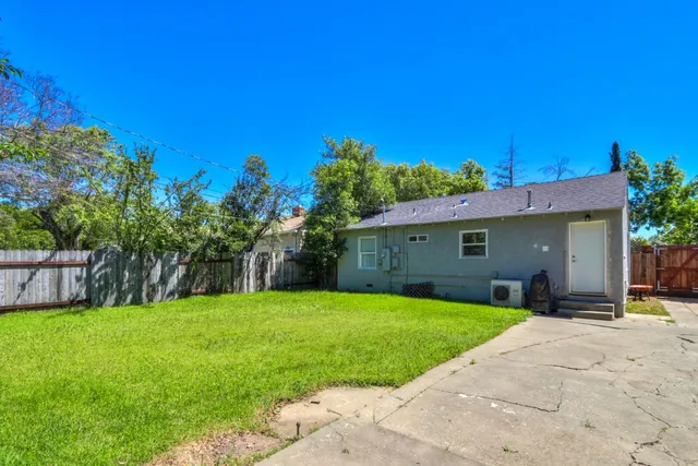 a front view of house with yard and trees