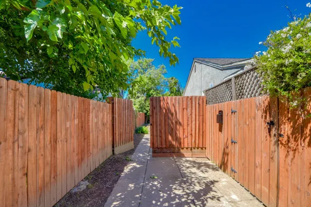 a view of a backyard with wooden fence