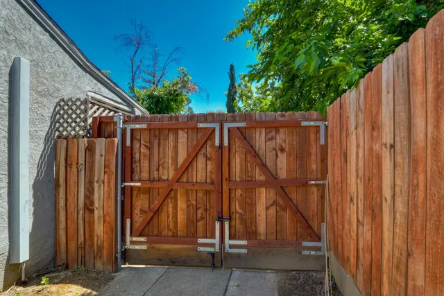 a view of a backyard with wooden fence